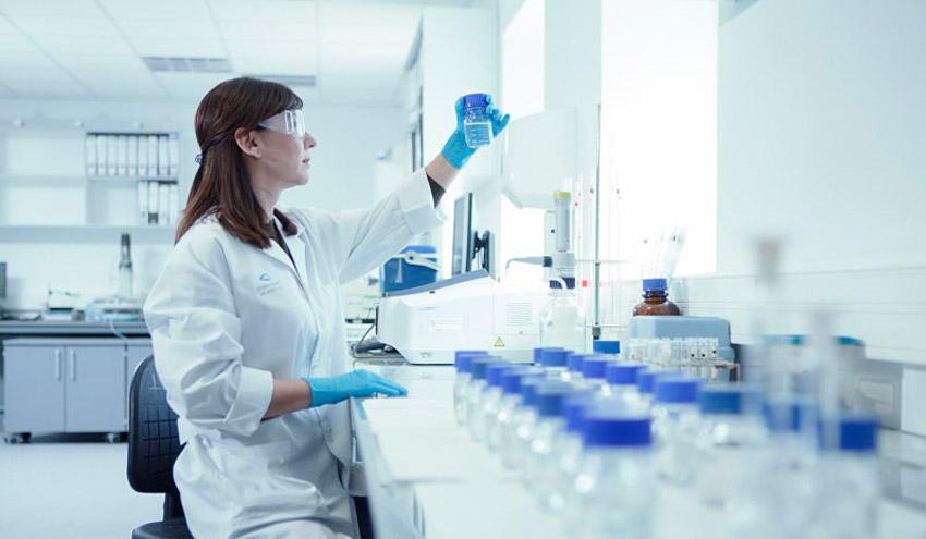 Laboratory technician examining water samples for quality testing and analysis